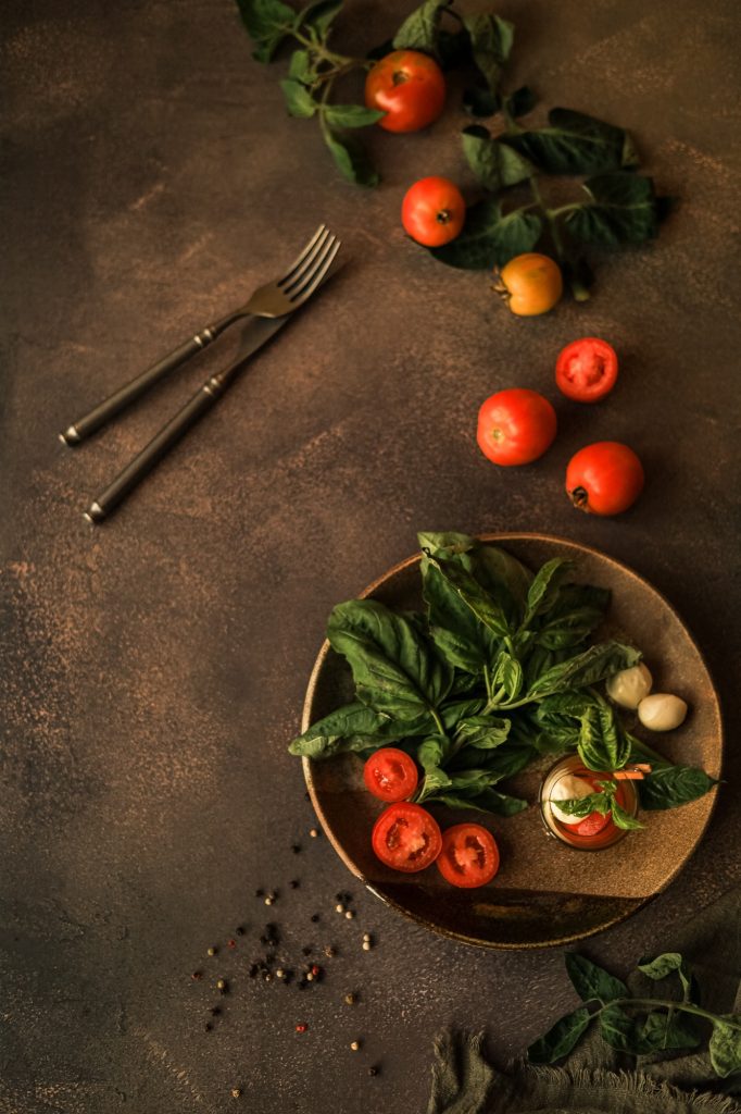 Caprese Salad in a Glass for Serving in a Ceramic Plate and the Ingredients for It. Italian Cuisine.